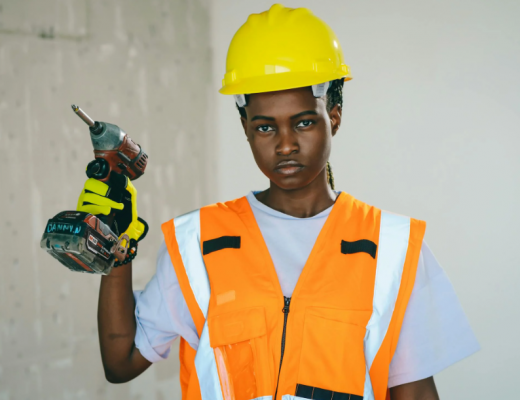 Female African American Construction Worker Holding a Drill