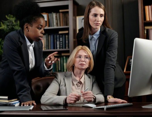 Group of 3 Female Attorneys Looking at a Computer Monitor