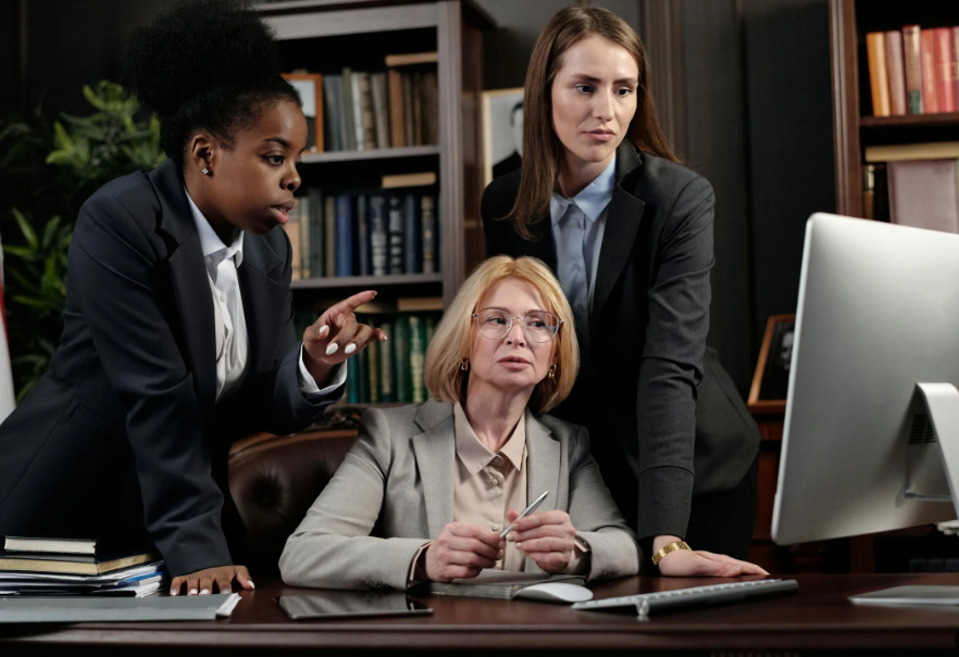 Group of 3 Female Attorneys Looking at a Computer Monitor