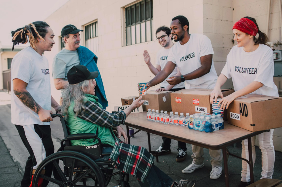 Volunteers Engaging with a Woman in a Wheelchair
