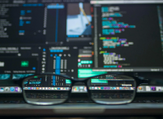 Close Up of Glasses Against a Background of Computer Code