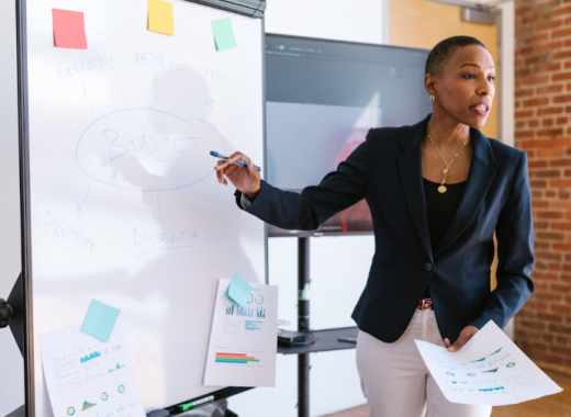 African American Woman Standing in Front of a Whiteboard