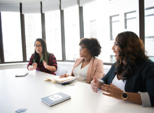 Group of Women Sitting at a Large Conference Table
