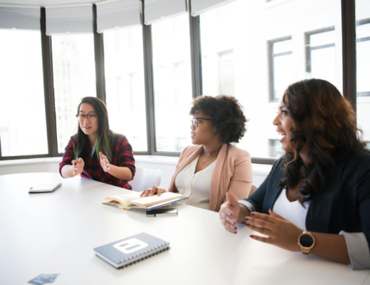 Group of Women Sitting at a Large Conference Table