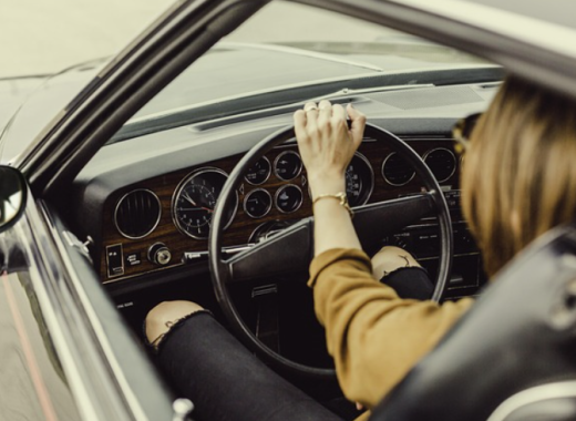 Woman Sitting in the Drivers Seat of a Car
