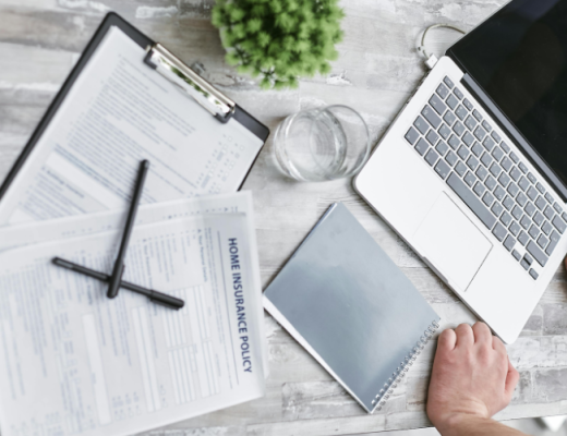 Laptop Sitting on a Desk with a Clipboard