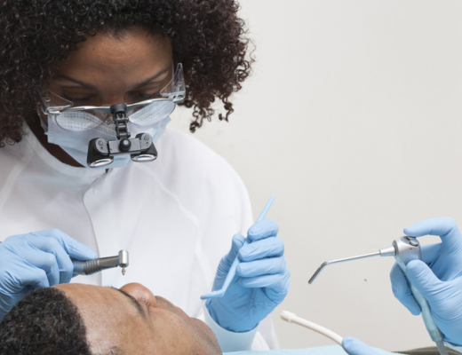 African American Female Dentist with a Patient