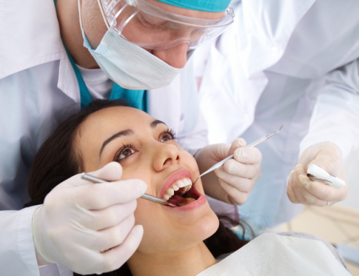 Caucasian Male Dentist Working on a Patient