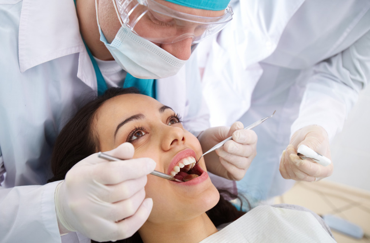 Caucasian Male Dentist Working on a Patient