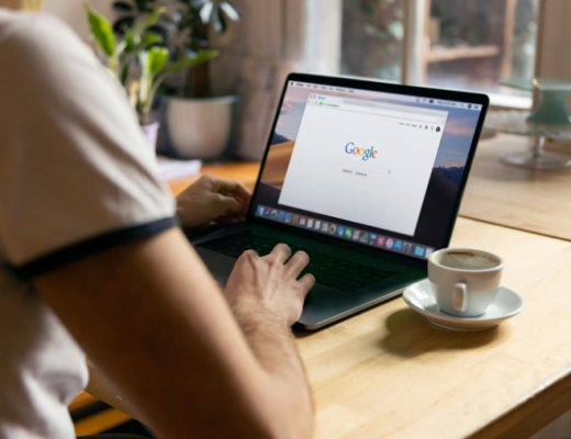 Woman Sitting at a Desk and Looking at Google Search on Her Laptop