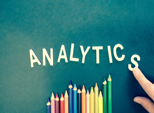 The Word Analytics Spelled Out Next to Colored Pencils