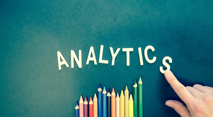 The Word Analytics Spelled Out Next to Colored Pencils