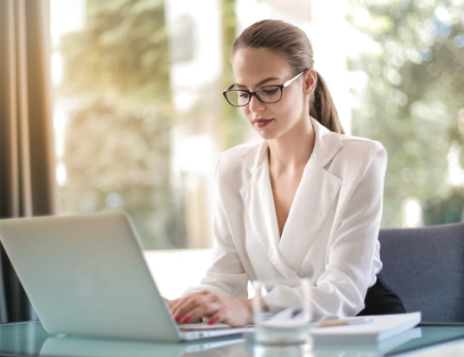 Caucasian Woman Wearing a White Blouse and Sitting at a Desk