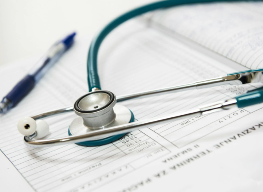 Stethoscope and Pen Sitting on Top of a Patient Medical Chart