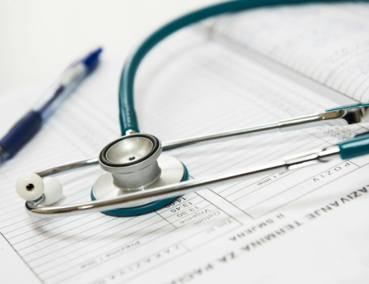 Stethoscope and Pen Sitting on Top of a Patient Medical Chart