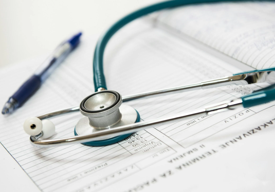 Stethoscope and Pen Sitting on Top of a Patient Medical Chart