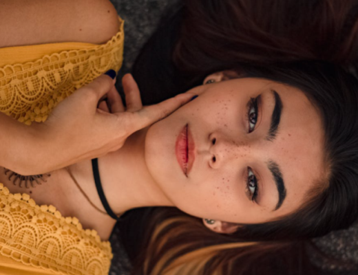Indian Woman Dressed in Yellow and Laying Sideways on the Ground