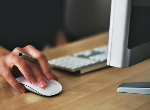 Woman with Her Hand Resting on an External Mouse