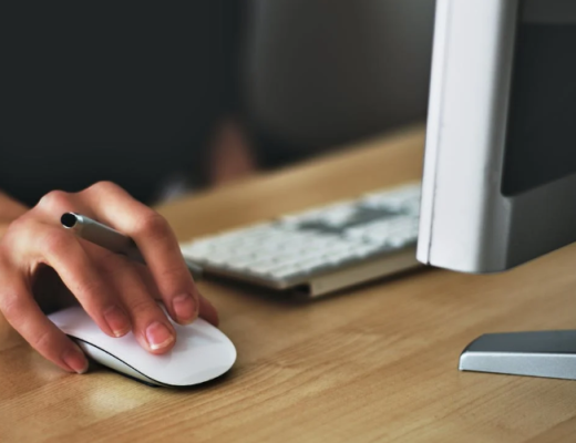 Woman with Her Hand Resting on an External Mouse