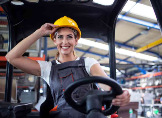 Smiling Woman Wearing a Hardhat at a Construction Site