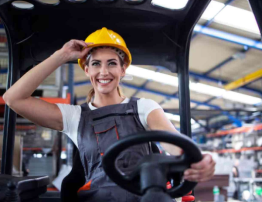 Smiling Woman Wearing a Hardhat at a Construction Site