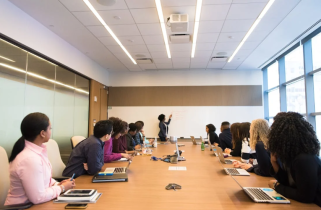 Group of People Sitting Around a Business Conference Table
