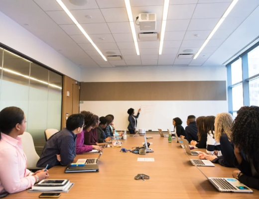 Group of People Sitting Around a Business Conference Table