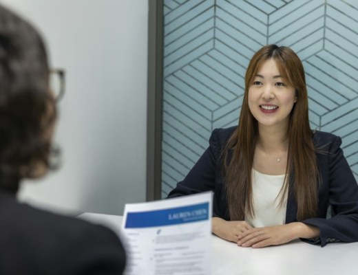 Woman Interviewing a Smiling Asian Woman for a Job Interview