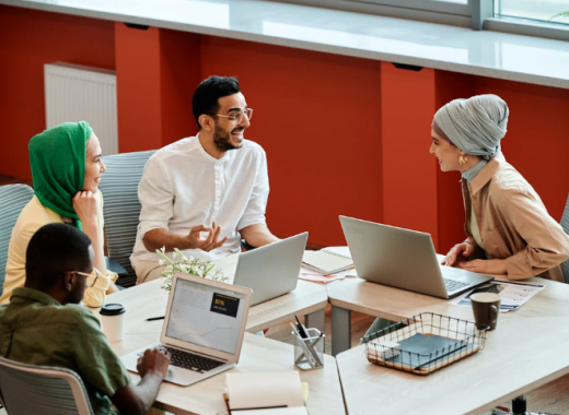 Smiling Group of Diverse People Sitting Around a Conference Table