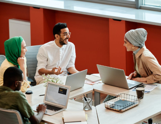 Smiling Group of Diverse People Sitting Around a Conference Table