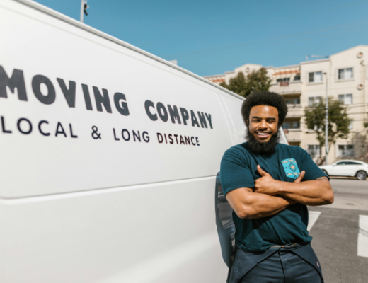 African American Man Standing Next to a Moving Truck