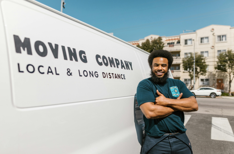 African American Man Standing Next to a Moving Truck