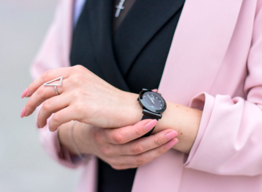 Woman Wearing a Pink Blazer and Holding Her Wrist