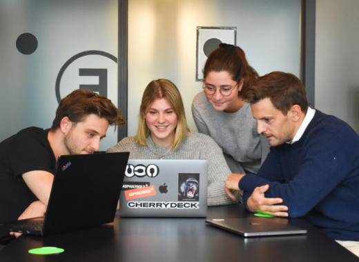 2 Female and 2 Male Millenials Looking at a Laptop Screen