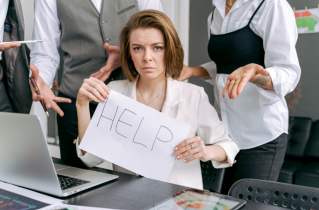 Businesswoman Holding a Handwritten Help Sign