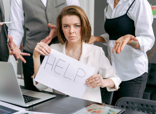 Businesswoman Holding a Handwritten Help Sign