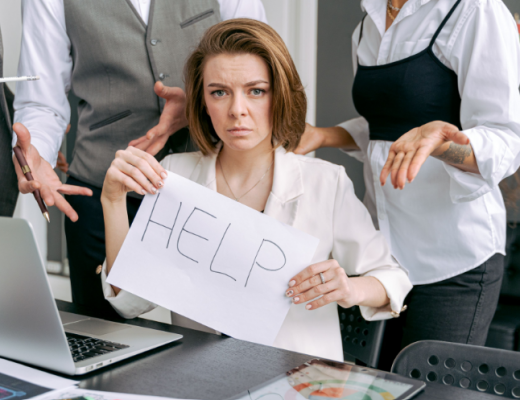 Businesswoman Holding a Handwritten Help Sign