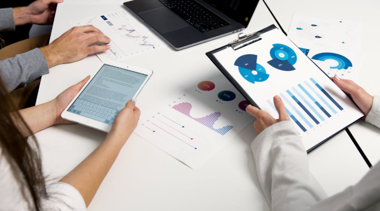 2 People Analyzing Business Charts and Graphs