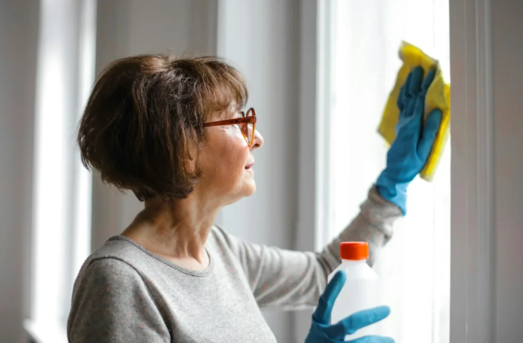 Older Woman Cleaning a Window