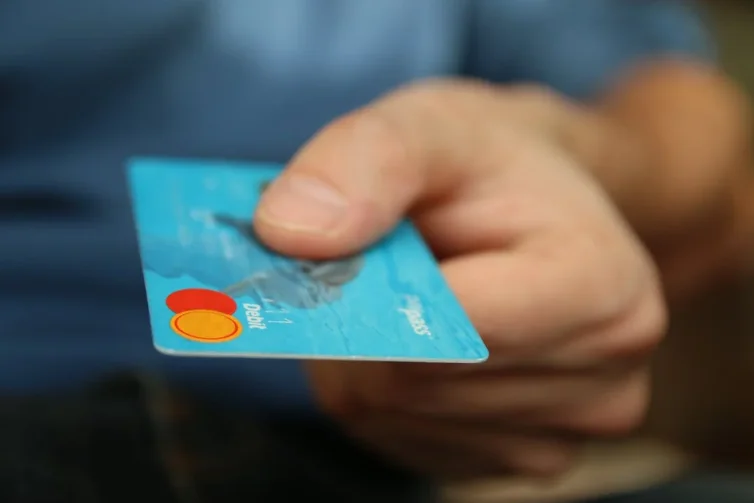 Close Up of a Hand Holding a Blue Mastercard