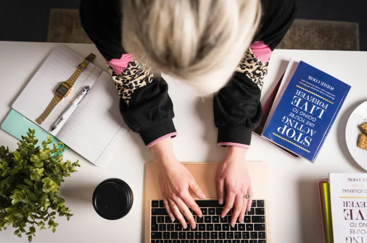 Arial View of a Woman Typing at a Desk
