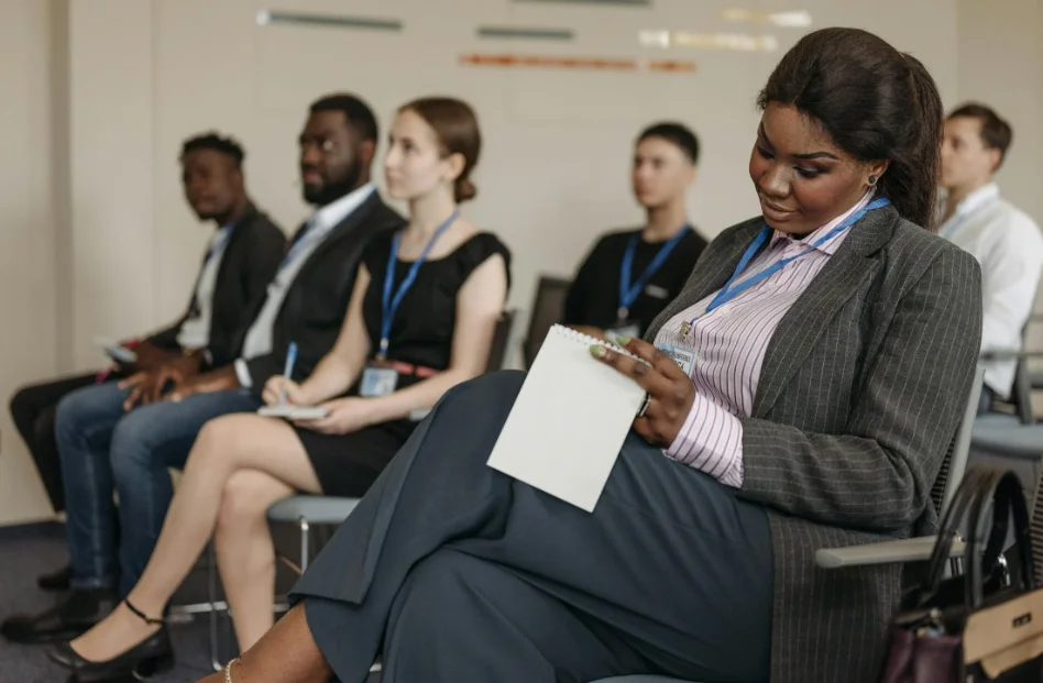 Diverse Group of People Attending a Small Conference