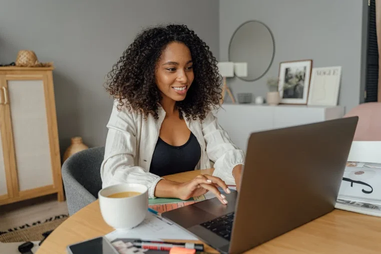 Smiling African American Woman Typing on a Laptop