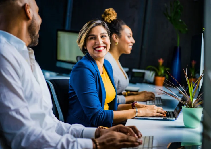 Smiling Woman Sitting in a Conference Room