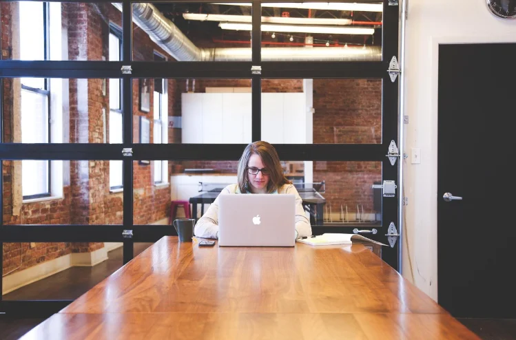 Woman Sitting at a Desk In An Office