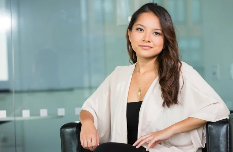 Business Woman with Long Brown Hair Posed in Office Chair