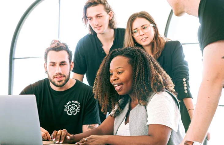 Diverse Group of 4 People Looking at a Computer Screen