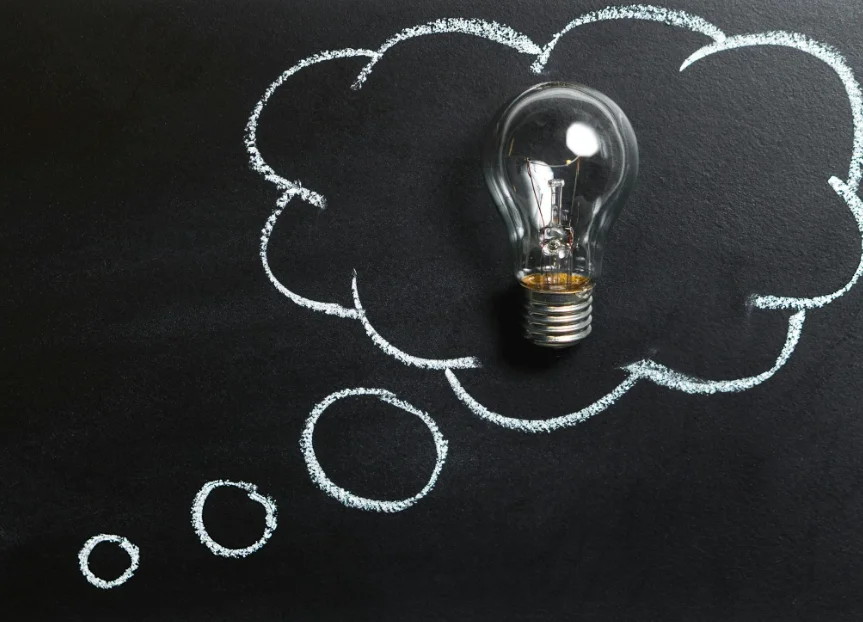 Lightbulb Surrounded by a Cloud Drawn on a Chalkboard