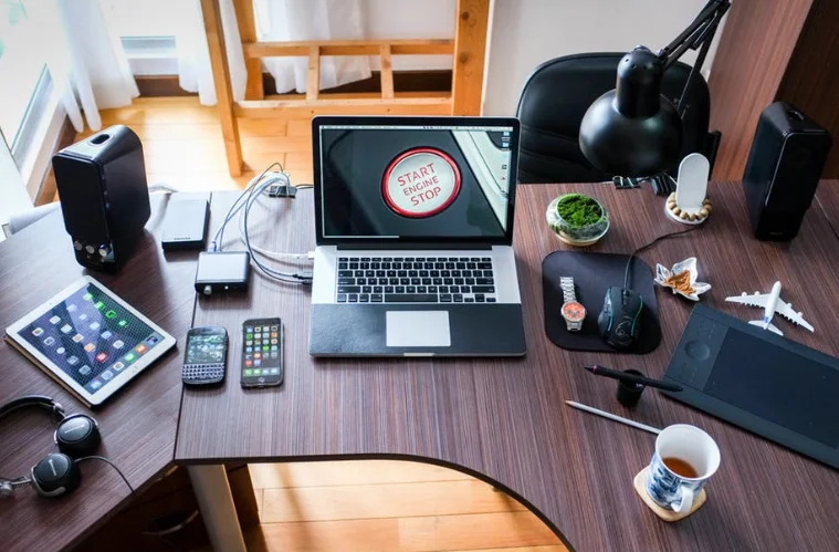Laptop and Cell Phones Sitting on an Organized Desk
