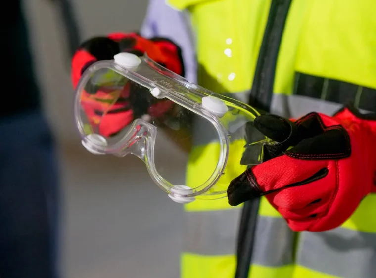 Close Up of Someone Holding Safety Goggles